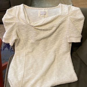 Short sleeve thin knit “sweater” in ivory color. Slant neckline.